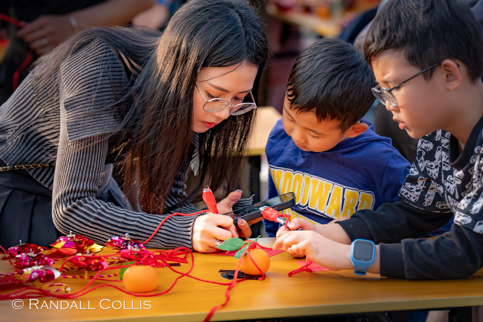 Lam Tsuen Well-wishing festival - Child and Mom Writing out Wishes